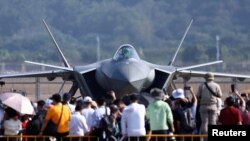 FILE - Visitors to the 15th Air Show in Zhuhai, Guangdong, China, view the Chinese Air Force's J-20 fighter jet, Nov. 12, 2024.