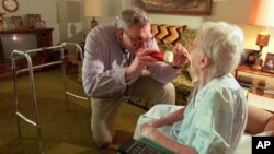 FILE - On a house call, Dr. Craig Krause examines a patient suffering from arthritis Thursday, March 9, 1995. 