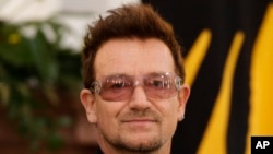 Irish singer Bono poses for media as he meets youth ambassadors of the ONE campaign together with with the President Joachim Gauck in Berlin, Oct. 8, 2012.