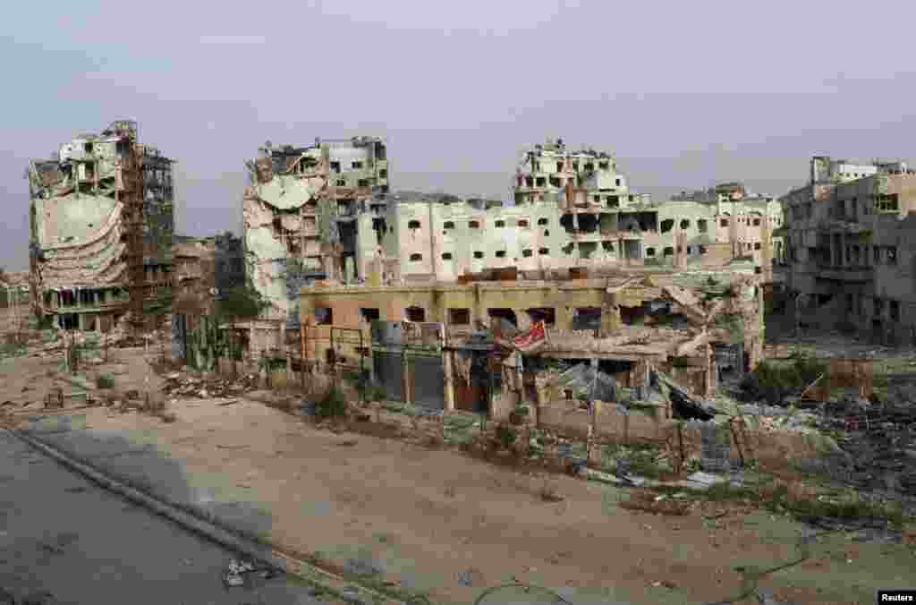 A view shows damaged buildings along a deserted street in the besieged area of Homs, Nov. 25, 2013.