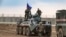 FILE - Russian troops with military vehicles are seen on patrol outside the town of Darbasiyah in Syria's northeastern Hasakeh province, on the border with Turkey, Nov. 1, 2019.