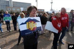 Participants in an anti-abortion rally gather in front of Planned Parenthood of the Rocky Mountains, in Denver, Feb. 11, 2017. Rallies urging Congress and President Donald Trump to end funding for Planned Parenthood were scheduled across the country.