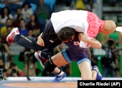 Japan's Risako Kawai celebrates after beating Belarus' Maryia Mamashuk for the gold during the women's wrestling freestyle 63-kg competition at the 2016 Summer Olympics in Rio de Janeiro, Brazil, Thursday, Aug. 18, 2016.