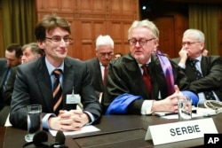FILE – William Schabas, in ribbons at center, has resigned as head of a commission examining alleged war crimes during last summer’s Gaza conflict. Here, he’s shown at The Hague’s International Court of Justice as part of a Serbian delegation in March 2014.