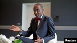 FILE - Nigeria's central bank governor Sanusi Lamido Sanusi gestures during an interview with Reuters in London.