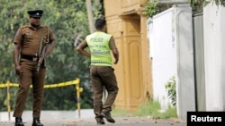 A Sri Lankan police officer walks into the motel where the Australian- and British-educated suicide bomber detonated his device inside, in Dehiwala on the outskirts of Colombo, Sri Lanka, April 26, 2019.