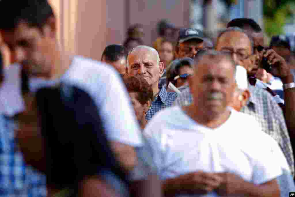 Voters wait to cast their ballots in San Juan, Puerto Rico. The U.S. island territory does not get a vote in the U.S. presidential election, but they are voting in a referendum that asks voters if they want to change the relationship to the U.S.