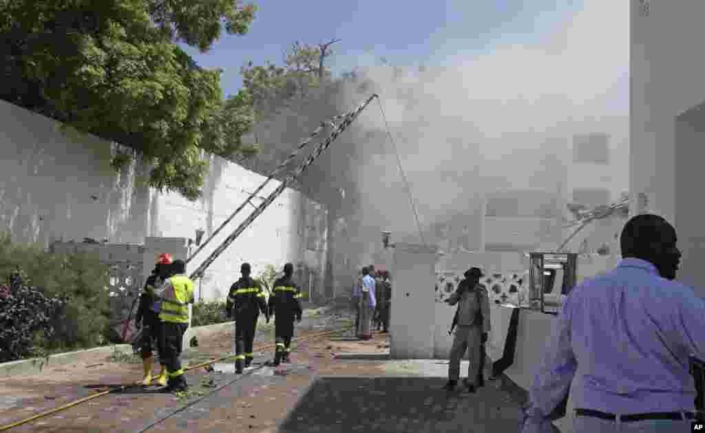 Smoke and steam from fires extinguished with water, clouds the scene of a twin bombing attack on a hotel in the capital Mogadishu, Somalia.