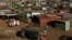 A fruit vendor waits for customers at an informal settlement in Thokoza, south of Johannesburg, South Africa, July 18, 2014. 