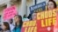 FILE - People hold signs at an anti-abortion rally at the Arkansas state Capitol in Little Rock, Ark., Jan. 18, 2015. 