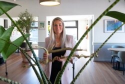 FILE - Femke Zimmerman, manager of Brasserie Berlage, a cafe and restaurant nestled in the manicured gardens of The Hague's historic art deco Kunstmuseum, poses for a portrait as she prepares the restaurant for reopening, April 24, 2020.