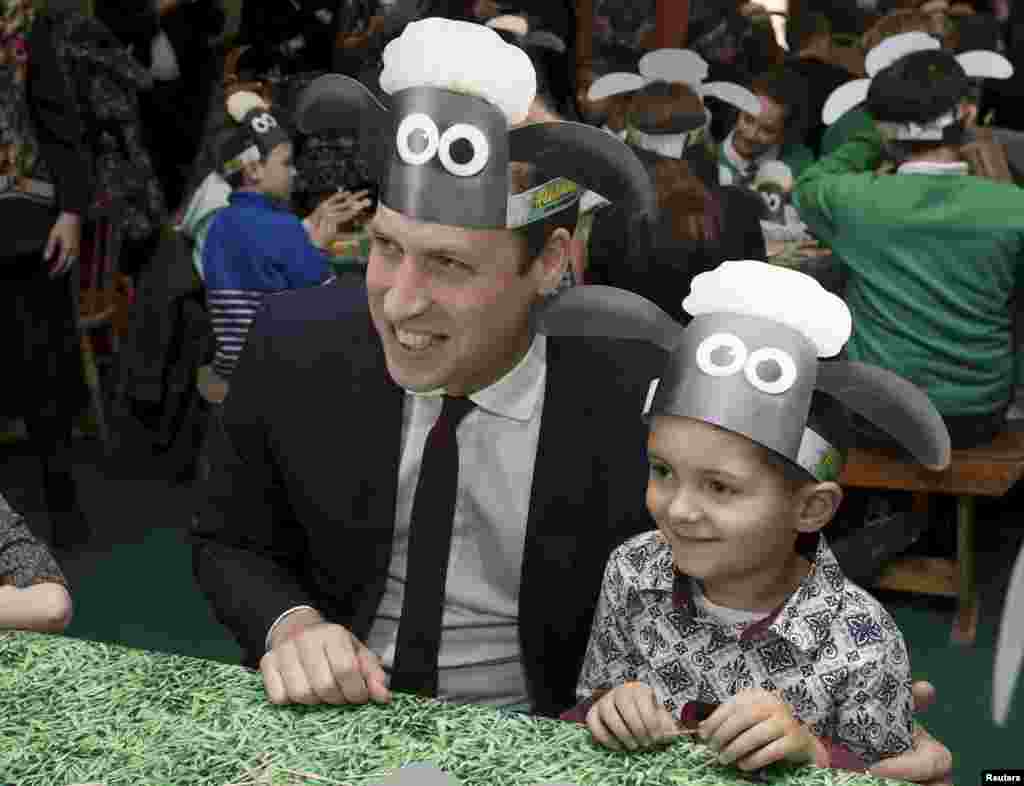 Britain&#39;s Prince William poses for photographs with a Shaun the Sheep hat, with children and representatives from charities and Aardman Animations, during a meeting of the Charities Forum at the British Academy of Film and Television Arts (BAFTA) in London.