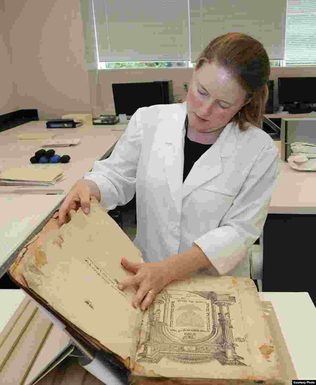 IJA conservator Katherine Kelly works on an artifact. (U.S. National Archives) 