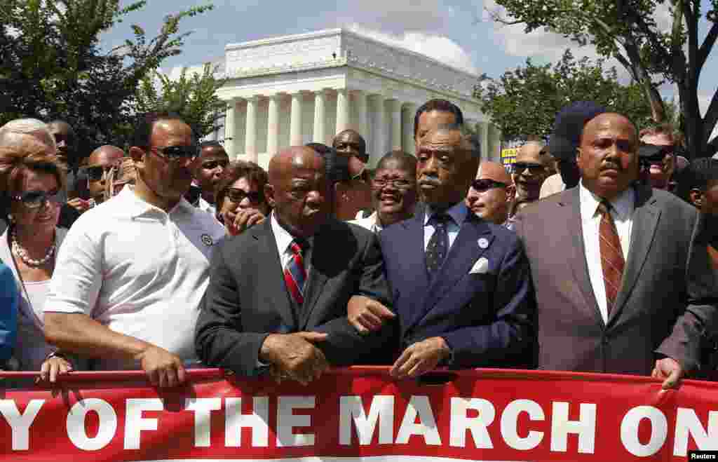 Rev. Al Sharpton (2nd R) links arms with Rep. John Lewis (D-GA) next to Martin Luther King III (R) as they begin to march during the 50th anniversary of the 1963 March on Washington for Jobs and Freedom at the Lincoln Memorial in Washington, Aug. 24, 2013