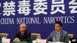 FILE - U.S. Drug Enforcement Administration's representative in Beijing, Lance Ho, right, speaks next to Wei Xiaojun, deputy director-general of the Narcotics Control Bureau of the Ministry of Public Security during a press conference in Beijing, earlier in November 2017. (AP Photo/Andy Wong) 