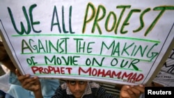 A Muslim youth holds up a placard during a protest against against the anti-Islam film, in Jammu, India Sept. 21, 2012.