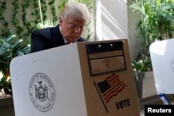 FILE - Republican presidential candidate Donald Trump fills his ballot for the New York primary election in the Manhattan borough of New York City, April 19, 2016.