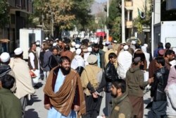 People gather outside of the Pakistan Embassy in Kabul, Afghanistan, Nov. 4, 2019.