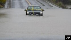 A car is left stranded on a flooded road during a storm Nov. 21, 2024, in Windsor, Calif.
