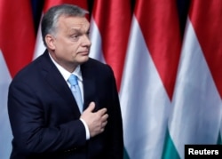 FILE - Hungarian Prime Minister Viktor Orban leaves the stage after delivering his annual state of the nation speech in Budapest, Hungary, Feb. 10, 2019.