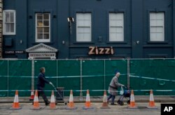 FILE - A police cordon and fence are placed outside a Zizzi restaurant near the area where former Russian double agent Sergei Skripal and his daughter were found critically ill following exposure to the Russian-developed nerve agent Novichok in Salisbury.