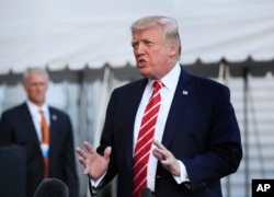 FILE - President Donald Trump speaks to reporters before leaving the White House in Washington for Greensboro, North Carolina, Oct. 7, 2017.
