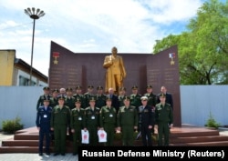 RUSSIA -- Russian military representatives pose in front of the memorial wall with Anatoliy Chepiga as the last name under the Gold Star honor list at the Far-Eastern Military Command Academy in Blagoveshensk, May 24, 2017