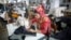FILE - A worker is seen sewing jeans in a garment factory in Savar, Bangladesh.