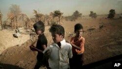 FILE - Homeless children stand on a road in Hodeidah, Yemen, Feb. 12, 2018.
