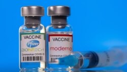 Vials with Pfizer-BioNTech and Moderna coronavirus disease (COVID-19) vaccine labels are seen in this illustration picture taken March 19, 2021. REUTERS/Dado Ruvic/Illustration/File