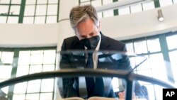 Secretary of State Antony Blinken signs a condolence book at the August 7 Memorial in Nairobi, Kenya, Nov. 17, 2021, which is one of the sites of the 1998 United States embassy bombings that left hundreds of people dead.
