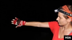 Vona Kuczynska releases brown bat after it has been weighed, measured, and checked for evidence of disease, Bellefontaine Cemetery, St. Louis, Missouri. (Veronique LaCapra)