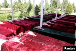 FILE - Coffins containing the bodies of Afghan national Army (ANA) soldiers killed in an April 21 attack on an army base are lined up in Mazar-i-Sharif, northern Afghanistan, April 22, 2017. The attack killed more than 140 Afghan soldiers.