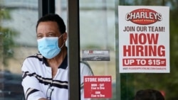 FILE: A patron leaves Charleys Philly Steaks restaurant, June 4, 2021, in Mayfield Heights, Ohio.