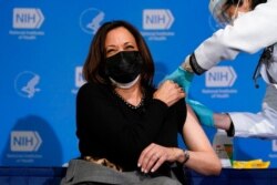 Vice President Kamala Harris reacts after receiving her second dose of the COVID-19 vaccine at the National Institutes of Health, in Bethesda, Md., Jan. 26, 2021.