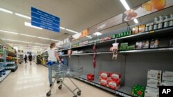 A view of empty shelves at a Tesco supermarket in Manchester, England, Sept 12, 2021. 