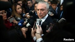 FILE - Brazil's President Michel Temer speaks to journalists at the Mercosur trade bloc summit in Mendoza, Argentina, July 21, 2017. 