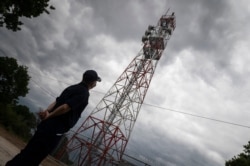 Police officer Dimosthenis Kamargios watches an electronic surveillance tower near the village of Lagyna, at the Greek -Turkish border, Greece, May 21, 2021.