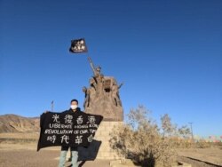 Alex Lee holds a flag after traveling on foot from West Covina to Barstow, California, in this undated photo. (Photo courtesy of Alex Lee)