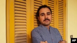 Egyptian author Ahmed Naji walks out of a Cairo police station, Dec. 22, 2016, after a court suspended his two-year prison sentence pending review of his appeal on obscenity charges.