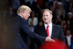 President Donald Trump talks with Republican candidate for Kansas' 2nd Congressional District Steve Watkins during a campaign rally at Kansas Expocentre, Oct. 6, 2018 in Topeka, Kan.