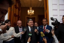 Lawmaker Luis Parra speaks to the press after many opposition lawmakers were blocked by police from entering the day's National Assembly session to elect a new leadership, in Caracas, Venezuela, Jan. 5, 2020.