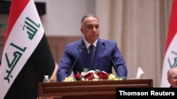 FILE - In this undated photo, Iraqi Prime Minister Mustafa al-Kadhimi delivers a speech at the parliament headquarters in Baghdad.