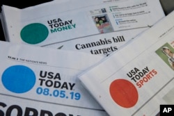 FILE - Sections of a USA Today newspaper on display, Aug. 5, 2019, in Norwood, Mass. USA Today and Gannett newspapers are testing artificial intelligence tools. (AP Photo)