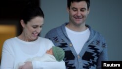 New Zealand Prime Minister Jacinda Ardern carries her newborn baby Neve Te Aroha Ardern Gayford with partner Clarke Gayford as she walks out of the Auckland Hospital in New Zealand, June 24, 2018.
