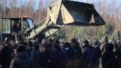 A polish serviceman prepares to repair a barbed wire fence to stop migrants gathering at the Belarus-Poland border near Grodno Grodno, Belarus, Nov. 9, 2021. (Leonid Shcheglov/BelTA via AP)