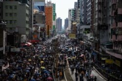 Protesters gather in Yuen Long district in Hong Kong, July 27, 2019. Crowds of Hong Kong protesters defied a police ban and gathered in a town near the Chinese border to rally against suspected gangs who beat up pro-democracy demonstrators there.