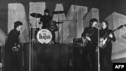 This photo taken on June 30, 1966 shows British band The Beatles, left to right, Paul McCartney, Ringo Starr, George Harrison and John Lennon, performing during their concert at the Budokan in Tokyo.