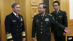 U.S. Navy Admiral Harry B. Harris, Jr., Commander U.S. Pacific Command (L) is shown the way by China's PLA Chief of Staff General Fang Fenghui (C) as they proceed to their meeting at the Bayi Building in Beijing, China, Nov. 3, 2015.