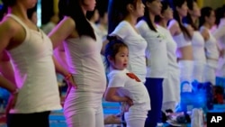 A child performs yoga at a hotel in Beijing, China, Sunday, June 21, 2015.
